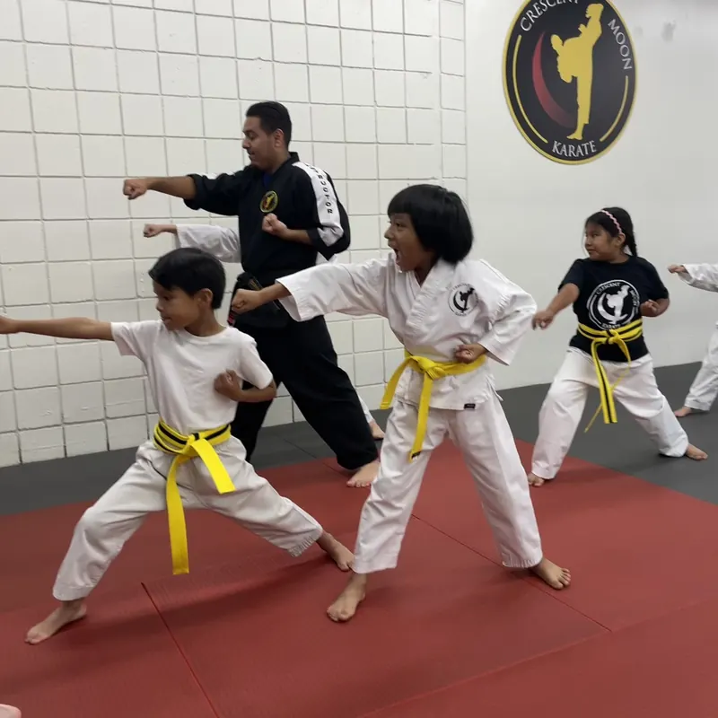 Students practice punches together in a structured group class led by their instructor